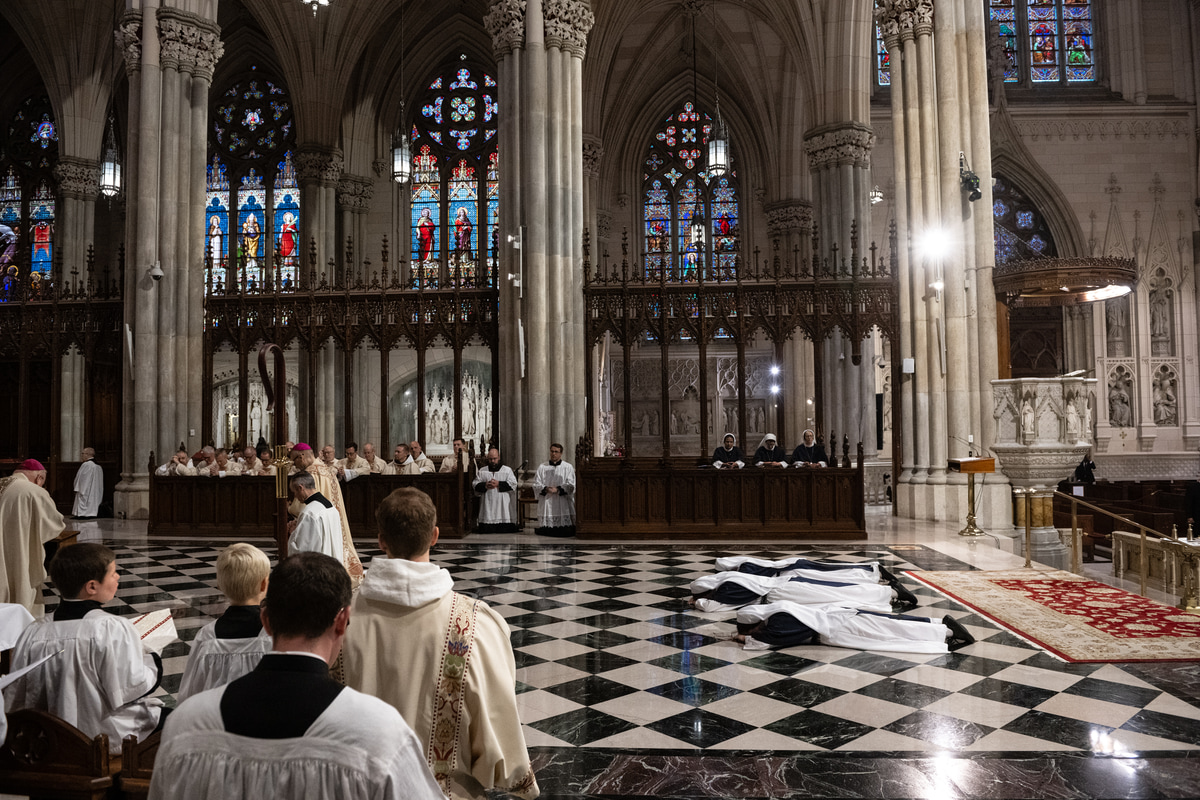 The three Sisters lie prostrate before the altar during the Litany of the Saints